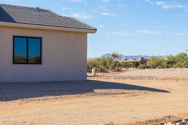 view of side of home with a mountain view