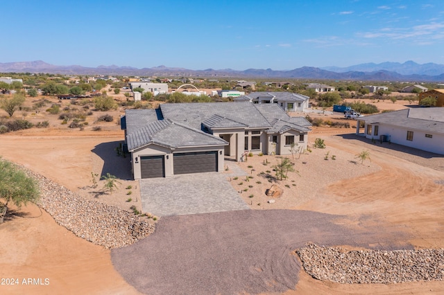 view of front of property with a mountain view and a garage