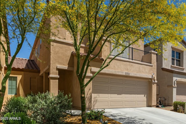 view of front of house with a garage, stucco siding, driveway, and a balcony
