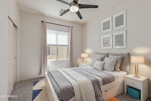bedroom featuring carpet flooring, ceiling fan, baseboards, visible vents, and a closet
