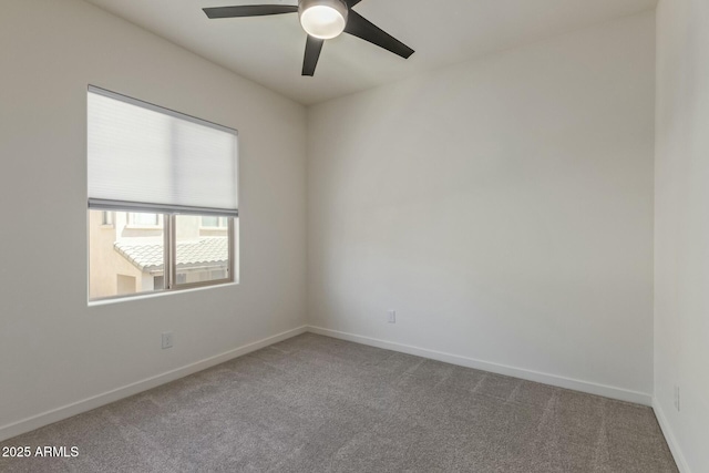 empty room with a ceiling fan, baseboards, and carpet