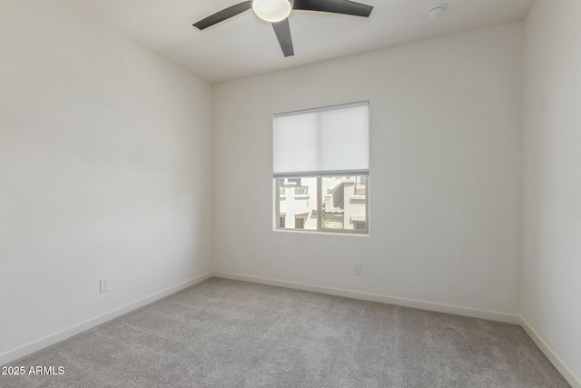 spare room with baseboards, carpet flooring, and ceiling fan