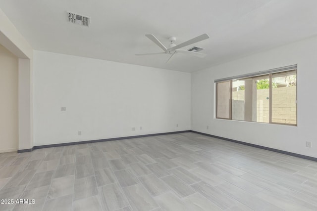 unfurnished room with visible vents, baseboards, and ceiling fan