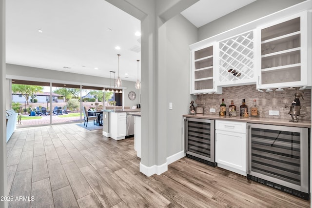 17565 E Blaze Ln, Rio Verde, AZ 85263 - indoor dry bar featuring wine cooler, wood finished floors, decorative backsplash, and recessed lighting