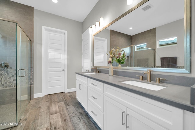 17565 E Blaze Ln, Rio Verde, AZ 85263 - full bathroom with double vanity, a shower stall, wood finished floors, baseboards, and recessed lighting