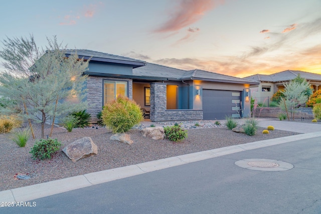 17565 E Blaze Ln, Rio Verde, AZ 85263 - prairie-style home with stone siding, stucco siding, an attached garage, and concrete driveway