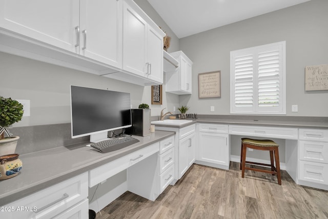 17565 E Blaze Ln, Rio Verde, AZ 85263 - office featuring built in desk, light wood-style floors, and a sink