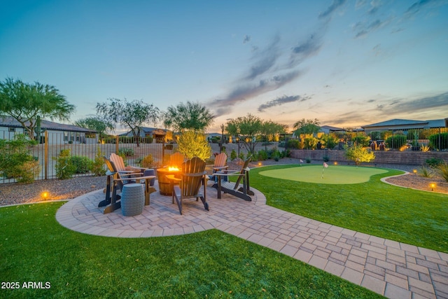 17565 E Blaze Ln, Rio Verde, AZ 85263 - view of patio with a putting green, an outdoor fire pit, and a residential view