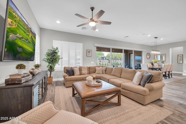 17565 E Blaze Ln, Rio Verde, AZ 85263 - living area featuring wood finished floors, a ceiling fan, recessed lighting, baseboards, and plenty of natural light