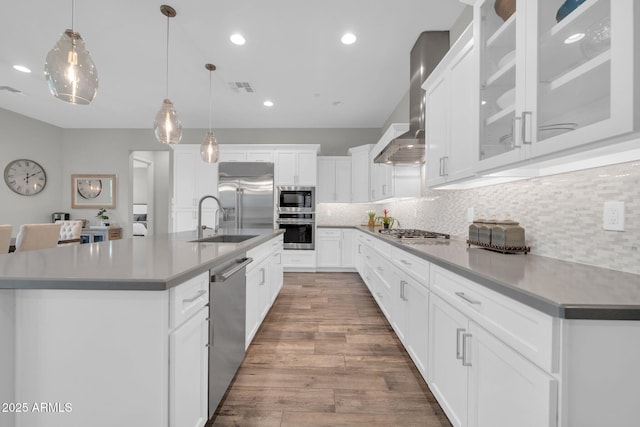 17565 E Blaze Ln, Rio Verde, AZ 85263 - kitchen with appliances with stainless steel finishes, a sink, wall chimney exhaust hood, backsplash, and wood finished floors