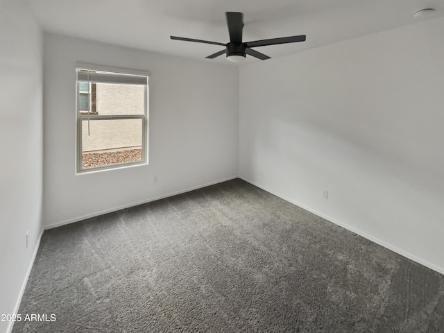 empty room with ceiling fan, carpet flooring, and baseboards