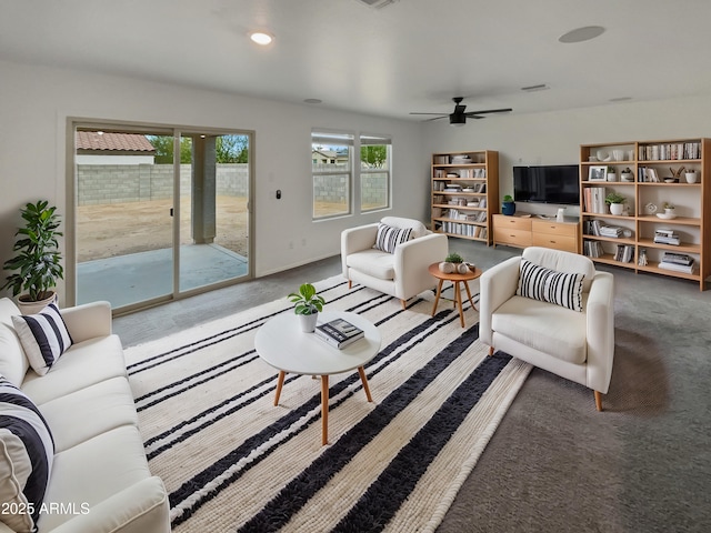 carpeted living room with a ceiling fan, recessed lighting, and baseboards