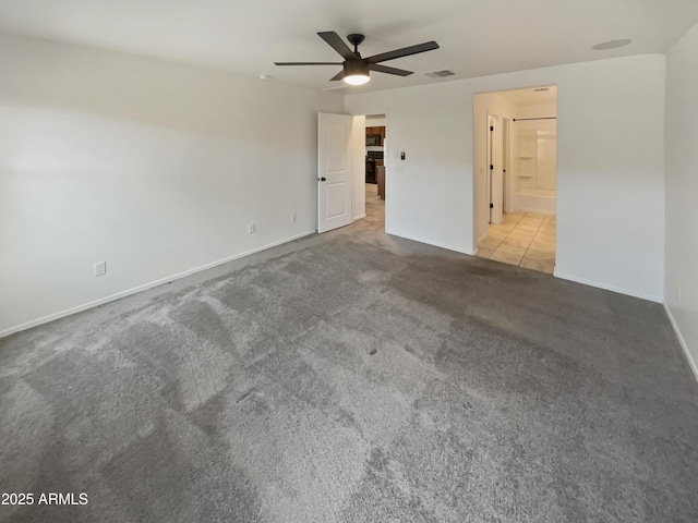 unfurnished bedroom featuring carpet floors, baseboards, visible vents, and a ceiling fan