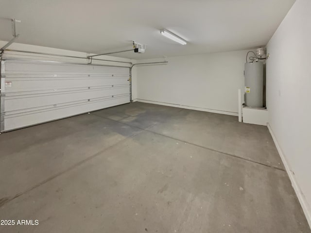 garage featuring water heater, baseboards, and a garage door opener