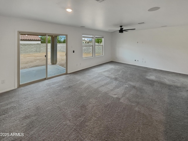 unfurnished living room with carpet floors, baseboards, and a ceiling fan