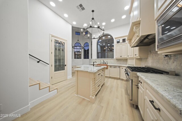 15641 E Sycamore Dr, Fountain Hills, AZ 85268 - kitchen featuring appliances with stainless steel finishes, a chandelier, backsplash, recessed lighting, and light wood-style floors