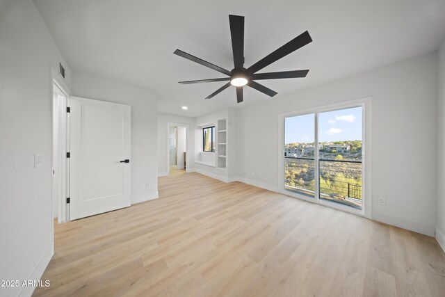 15641 E Sycamore Dr, Fountain Hills, AZ 85268 - empty room featuring light wood-style flooring, baseboards, and a ceiling fan