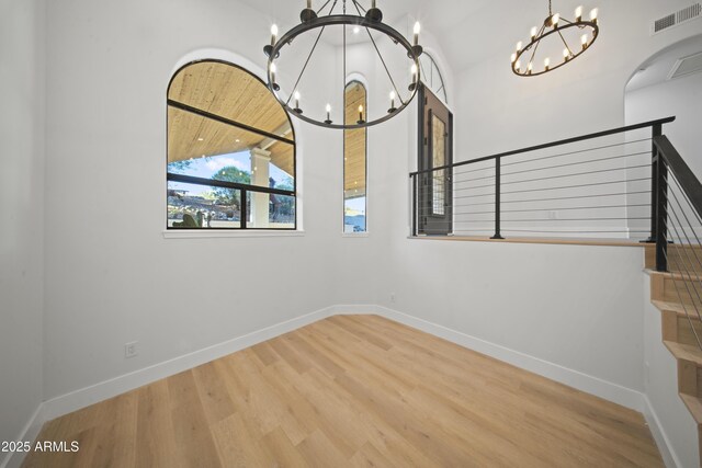 15641 E Sycamore Dr, Fountain Hills, AZ 85268 - unfurnished room with a chandelier, wood finished floors, stairway, and baseboards