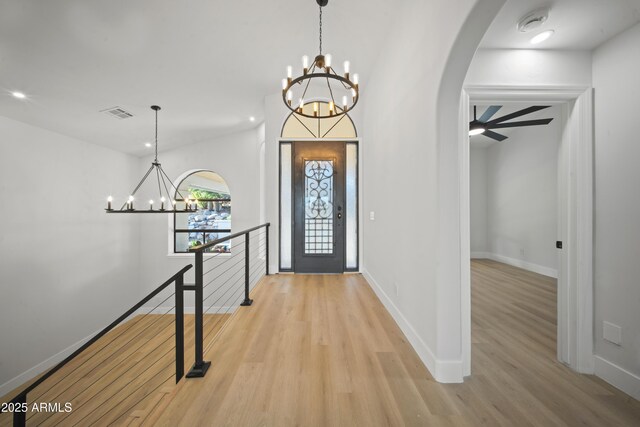 15641 E Sycamore Dr, Fountain Hills, AZ 85268 - foyer featuring a chandelier, arched walkways, light wood-style floors, baseboards, and recessed lighting