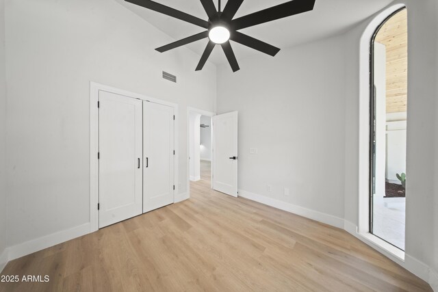 15641 E Sycamore Dr, Fountain Hills, AZ 85268 - unfurnished bedroom with high vaulted ceiling, baseboards, wood finished floors, a closet, and a ceiling fan