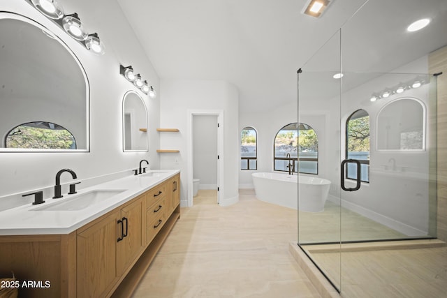 15641 E Sycamore Dr, Fountain Hills, AZ 85268 - bathroom featuring baseboards, a freestanding tub, double vanity, toilet, and a shower with door