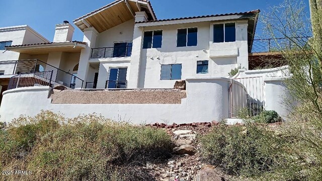 15641 E Sycamore Dr, Fountain Hills, AZ 85268 - back of house featuring stucco siding, a chimney, and a tile roof