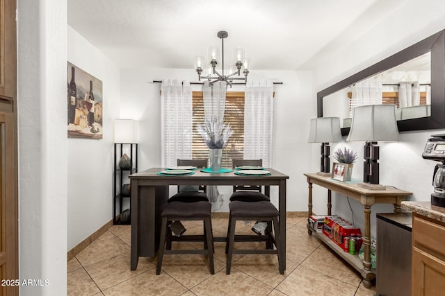 tiled dining space featuring a chandelier