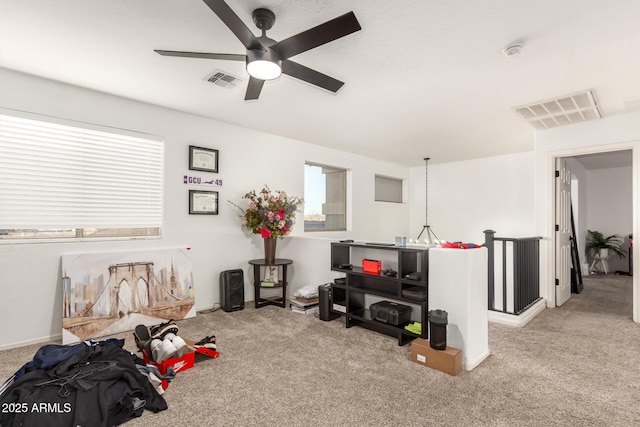 misc room with light colored carpet and ceiling fan