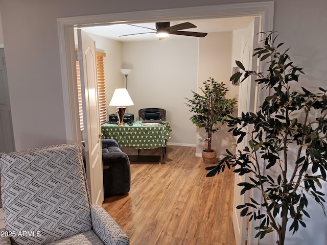 sitting room with ceiling fan and light hardwood / wood-style flooring