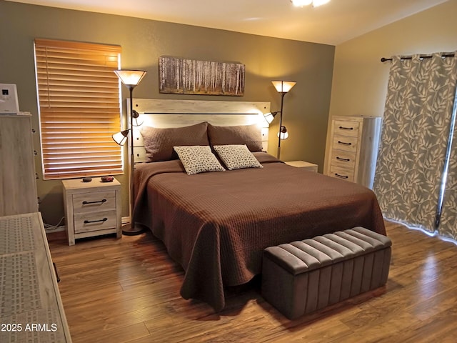 bedroom featuring vaulted ceiling and dark hardwood / wood-style floors