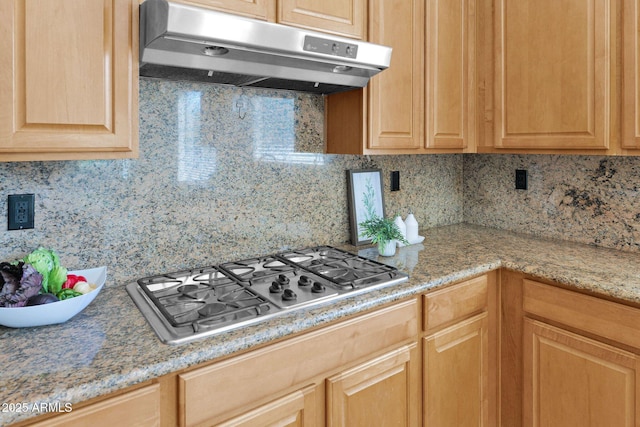 kitchen featuring stainless steel gas stovetop, decorative backsplash, and light brown cabinets