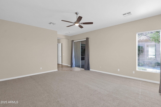 empty room featuring ceiling fan and light colored carpet