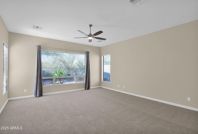 carpeted spare room with ceiling fan