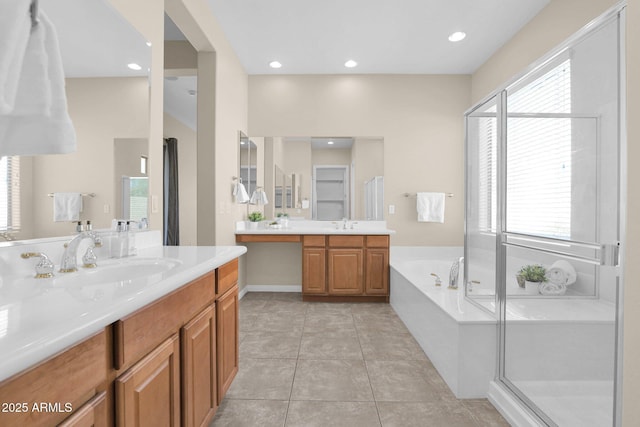 bathroom with tile patterned flooring, vanity, and shower with separate bathtub