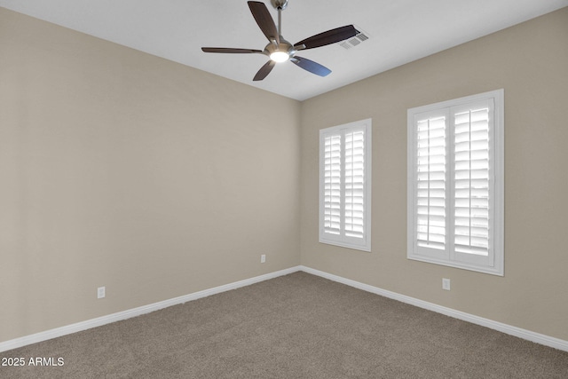 carpeted spare room with ceiling fan