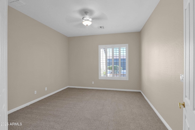 spare room featuring carpet and ceiling fan