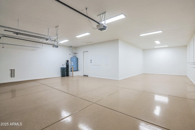 garage with gas water heater and a garage door opener