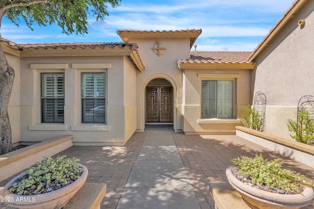 view of exterior entry featuring a patio