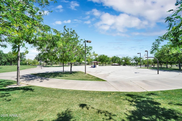 view of basketball court with a yard