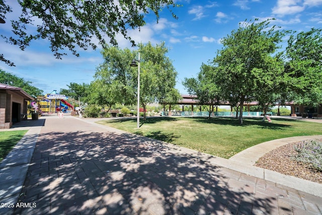 view of community featuring a lawn and a playground