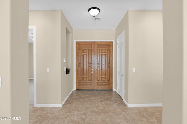 entryway with light tile patterned floors