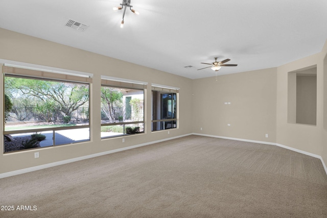 empty room featuring carpet and ceiling fan