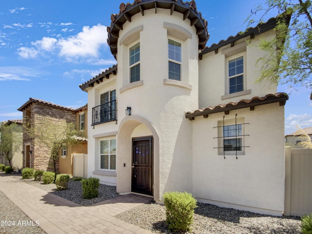 mediterranean / spanish-style home with a balcony