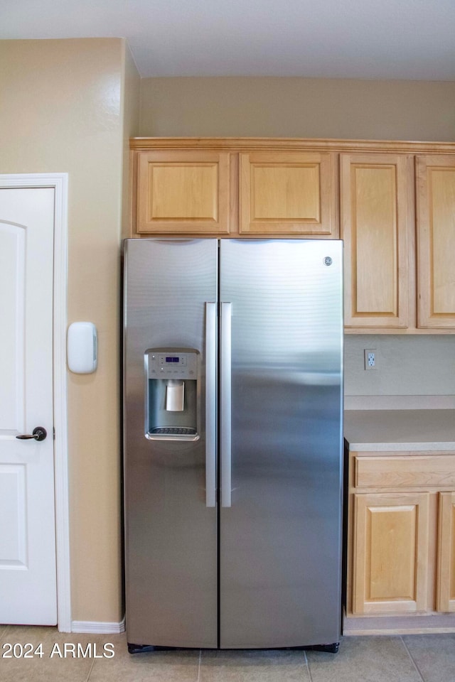 kitchen featuring light brown cabinets, stainless steel refrigerator with ice dispenser, and light tile patterned floors