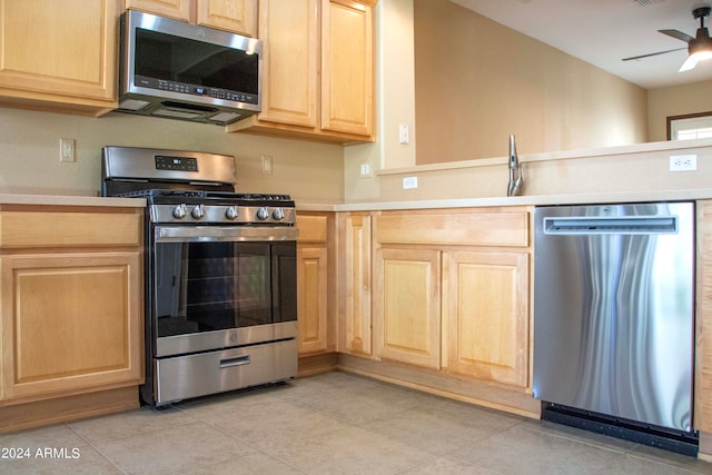 kitchen with light tile patterned flooring, light brown cabinetry, ceiling fan, and stainless steel appliances