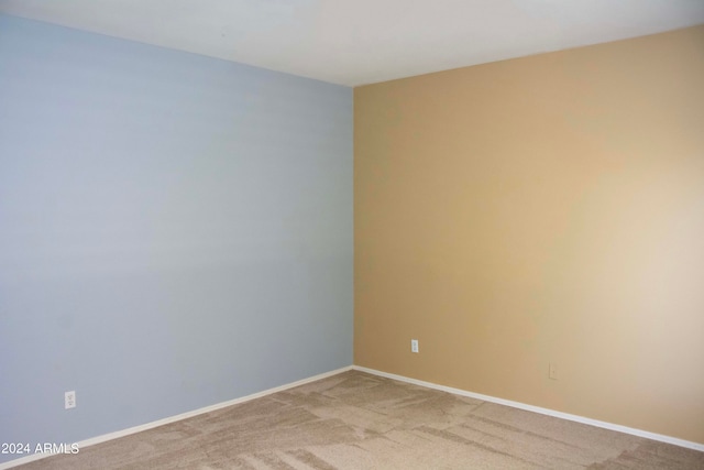 unfurnished room featuring light colored carpet