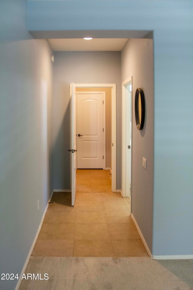 corridor with light tile patterned floors