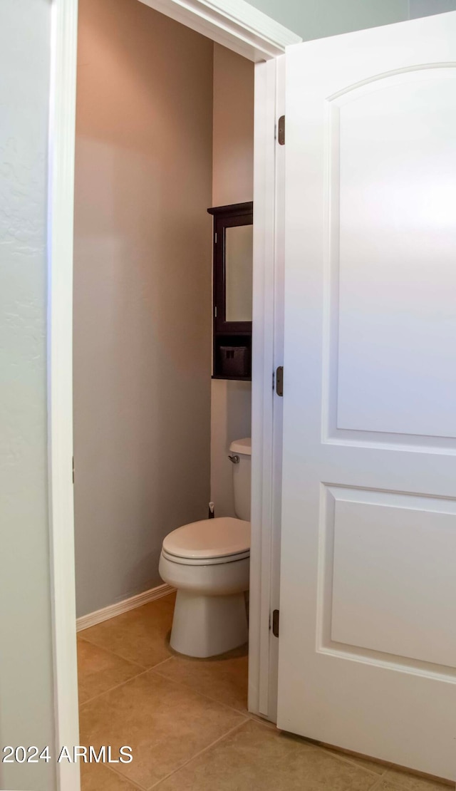 bathroom with tile patterned flooring and toilet