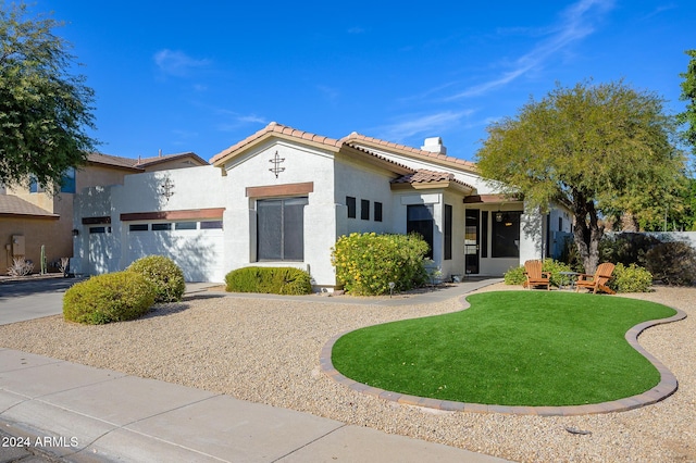 view of front of property featuring a garage and a front yard