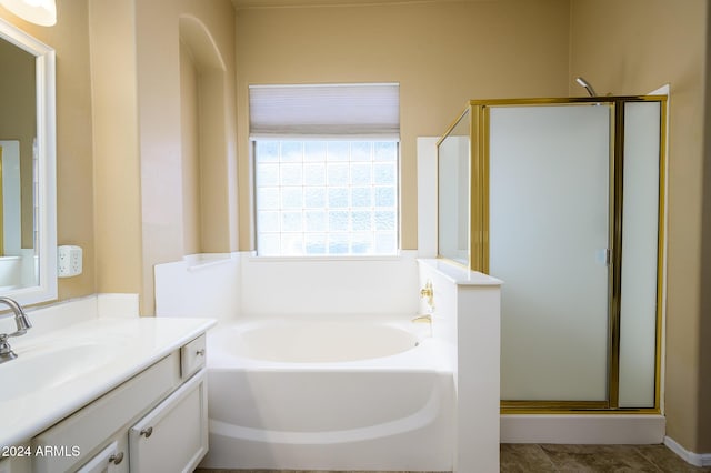 bathroom featuring vanity and shower with separate bathtub